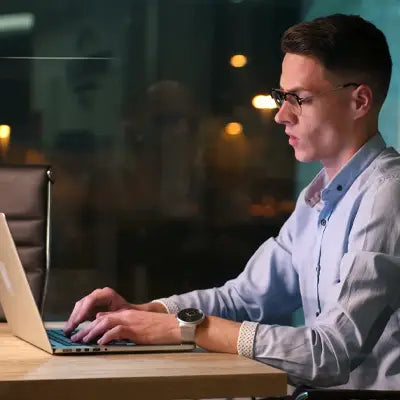 Man using laptop with Health-Enhancing Herbal Tea featuring Hovenia Dulcis Thunb Tangerine Peel and Volatile Oils