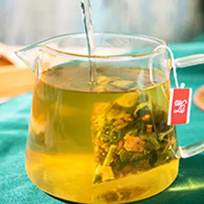 Glass pitcher of colon cleansing tea with tangerine peel, traditional Chinese medicine herbal tea
