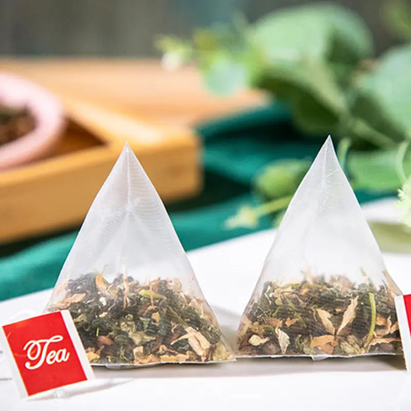 Two pyramid tea bags of colon cleansing tea with tangerine peel, Traditional Chinese Medicine herbal tea