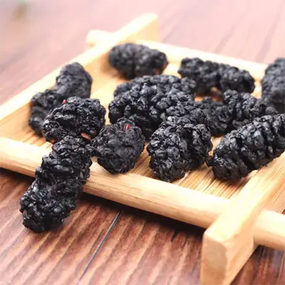 Dried mulberries on a wooden tray for Sleep Tea enhancing sleep quality with herbal tea