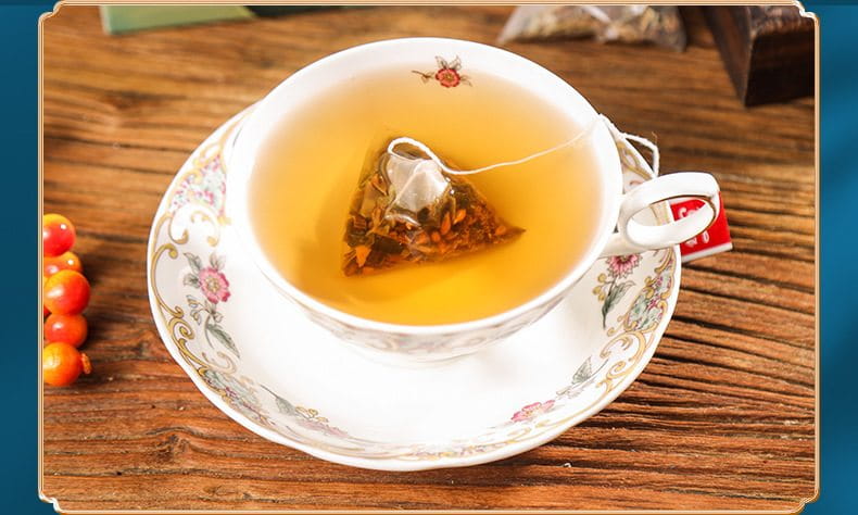 Floral teacup with tea bag showcasing slimming tea and health-enhancing herbal tea