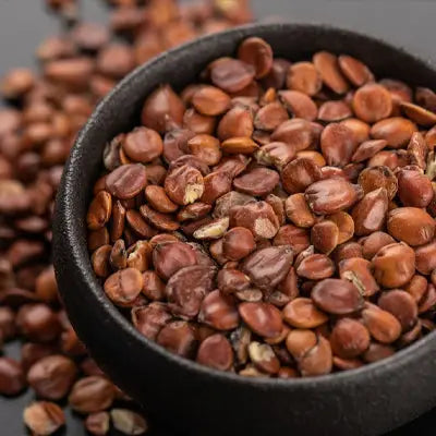 Bowl of brown Pina Date Seeds for herbal tea to enhance sleep quality