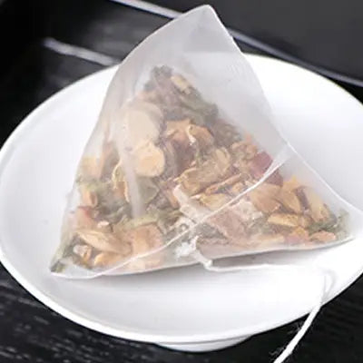Triangular herbal tea bag for stomach health, ideal for golden hour consumption after irregular diet