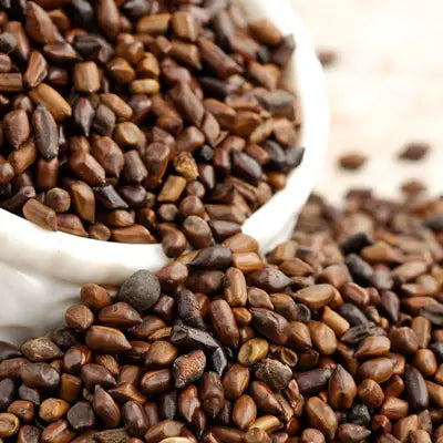 Pile of dark brown seeds for Slimming Tea promoting intestinal motility during golden hour