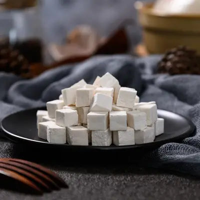 White cube-shaped Pina Date Seed herbal tea for improving sleep quality