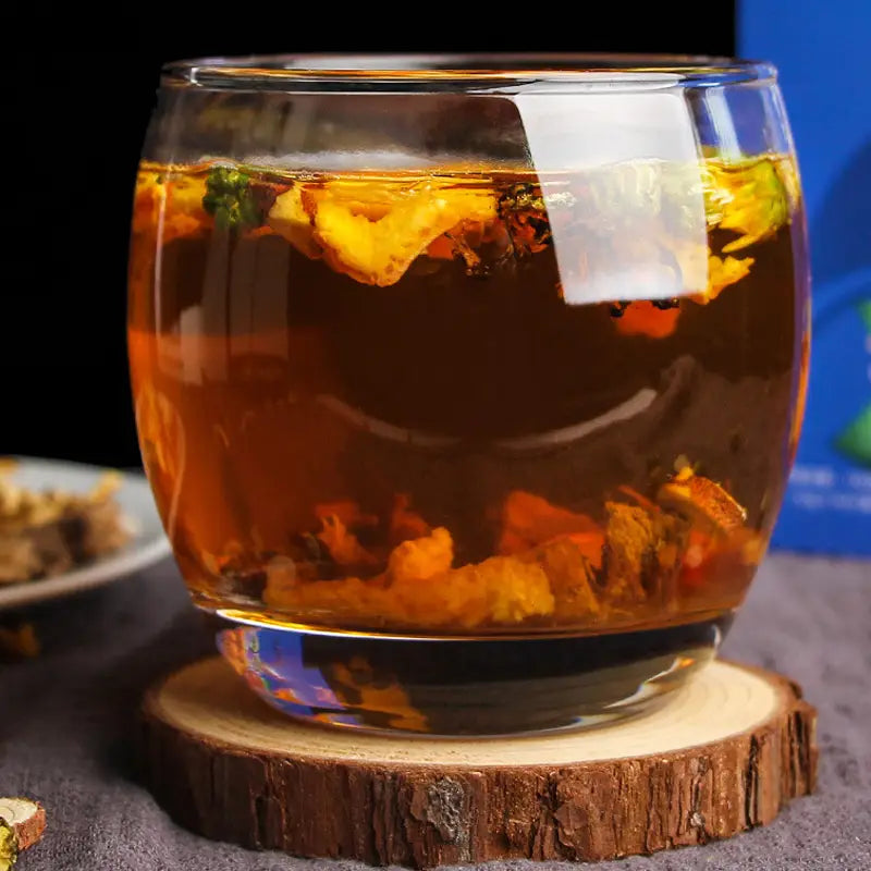 Glass cup of herbal tea with Hovenia Dulcis Thunb, tangerine peel, and volatile oils