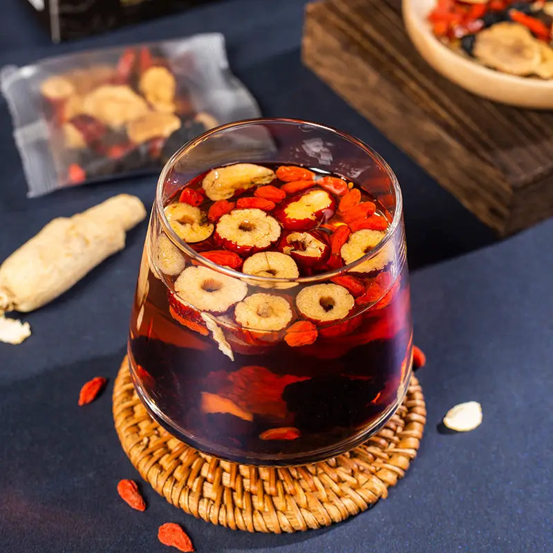 Glass of herbal tea with jujubes and goji berries promoting kidney health and renal protection