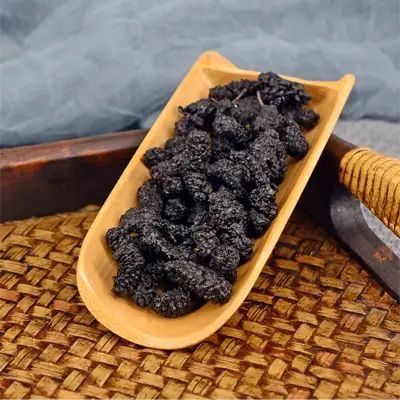 Dried mulberries in wooden scoop for Sleep Tea with Pina Date Seed herbal tea for better sleep quality