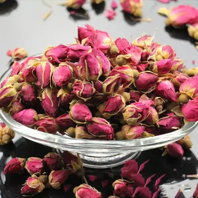 Dried rosebuds in glass bowl for herbal tea promoting blood circulation and alleviating menstrual pain