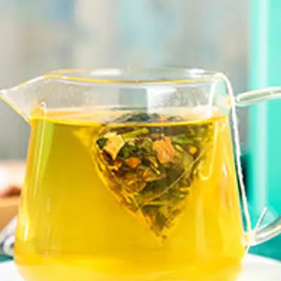 Glass teapot with tea bag featuring tangerine peel for colon cleansing tea from traditional Chinese medicine