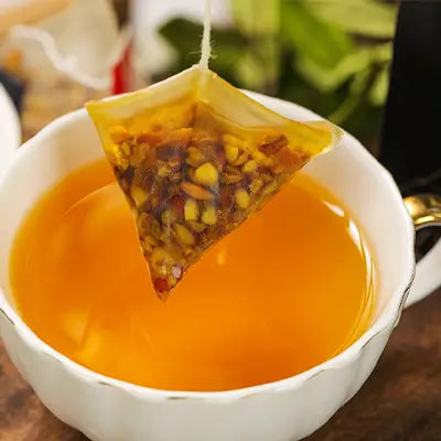 Triangular herbal tea bag steeping in cup supporting detox with tangerine peel for expulsion