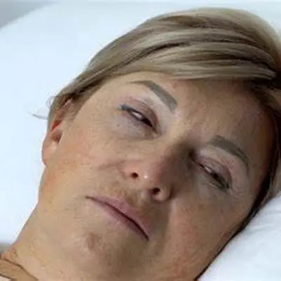 Woman lying down with Red Bean Barley Tea supporting detoxification and herb tea for detox