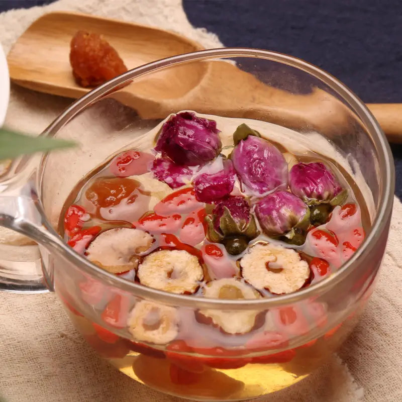 Floral herbal tea in glass mug promotes blood circulation and alleviates menstrual pain