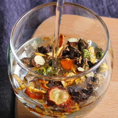 Glass bowl of herbal tea with Hovenia Dulcis Thunb and tangerine peel aroma rich in volatile oils