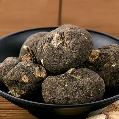 Black maca roots in bowl for kidney health and renal protection herbal tea