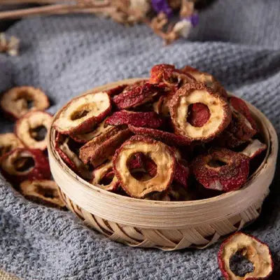 Dried hawthorn slices with hovenia dulcis thunb and tangerine peel in a woven bowl with volatile oils
