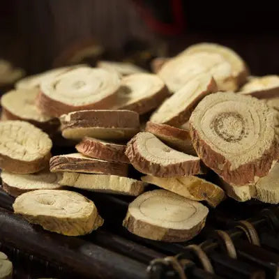 Sliced dried licorice root in Slimming Tea Hydrating Herbal Tea promoting intestinal motility