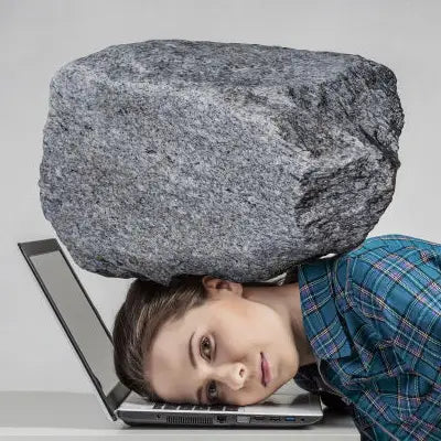 Overwhelmed woman with rock on head enjoying Red Bean Barley Tea supporting detox processes