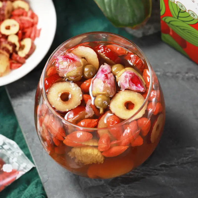 Glass bowl of herbal tea for cramps alleviating menstrual pain and promoting blood circulation