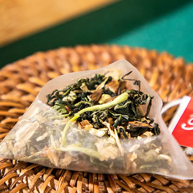 Pyramid tea bag filled with loose herbal tea with tangerine peel for colon cleansing