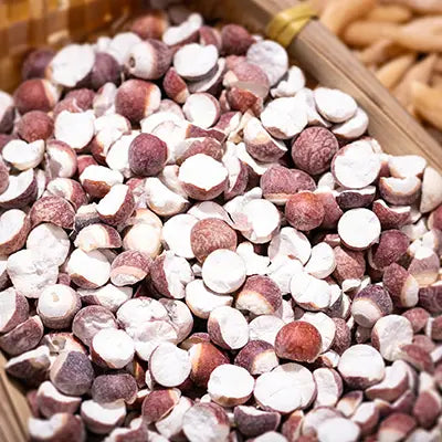 Sliced lotus seeds in herbal tea supporting detoxification and featuring tangerine peel for expulsion