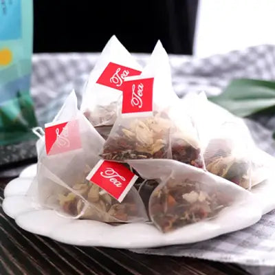 Pyramid-shaped herbal tea bags with poria cocos for antioxidant health benefits