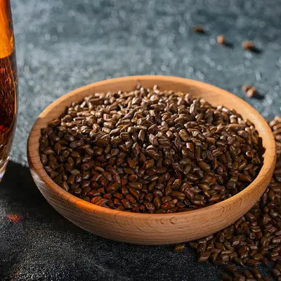 Wooden bowl with brown seeds for Slimming Tea Herbal Tea promoting intestinal motility during golden hour