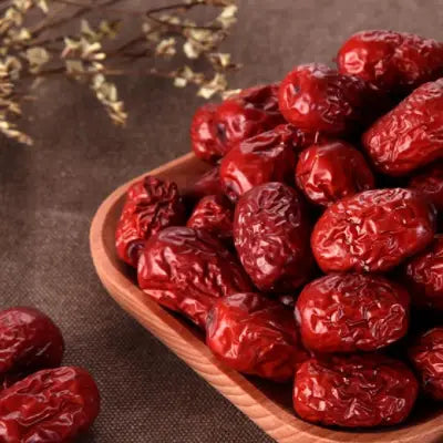 Shiny, wrinkled red Jujubes in Sleep Tea with Pina Date Seed for better sleep quality