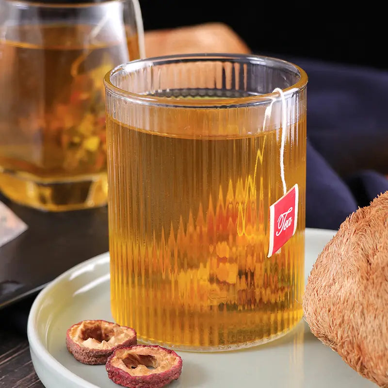 Glass of amber herbal tea for stomach health during golden hour, perfect for irregular diet