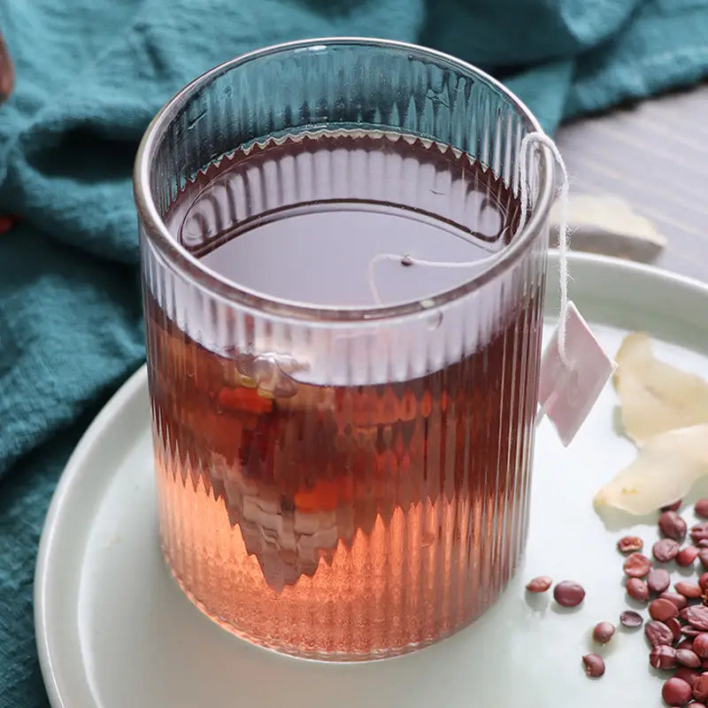 Ribbed glass of red Sleep Tea Herbal Tea with Pina Date Seed for better sleep quality
