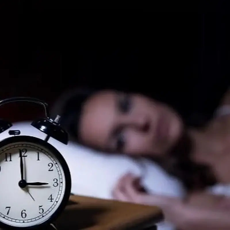 Black and white alarm clock for improved sleep quality with Pina Date Seed herbal tea