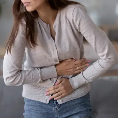 Woman experiencing stomach pain with Dysmenorrhea Tea Herbal Tea for alleviating menstrual pain