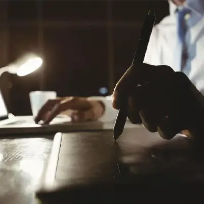 Person holding a pen with Gout Tea Health-Enhancing Herbal Tea featuring poria cocos and antioxidants