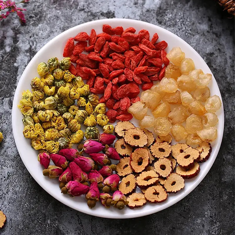 Dried herbal ingredients on a plate for alleviating menstrual pain and promoting blood circulation