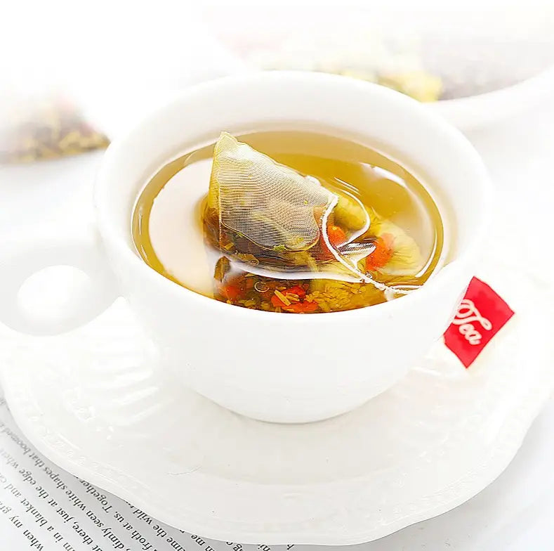 White teacup with tea bag for Liver Detox Herbal Tea with Chrysanthemum Cassia Seed