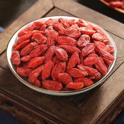 Bowl of dried goji berries for sleep quality in herbal tea with Pina Date Seed