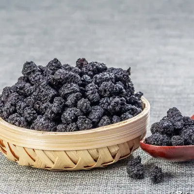 Dried mulberries in a woven bowl for kidney health and renal protection in herbal tea