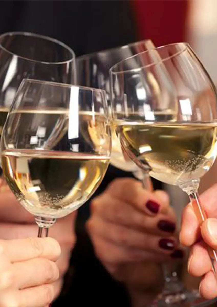 Clinking wine glasses filled with white wine for Liver Tea Health-Enhancing Herbal Tea detox