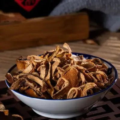 Bowl of dried orange peels for herbal tea to support digestion during golden hour