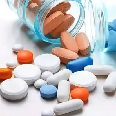 Assorted pills spilling from a bottle for Health-Enhancing Herbal Tea with Hovenia Dulcis Thunb and Tangerine Peel complexities