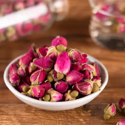 Dried rosebuds in bowl promoting intestinal motility for slimming tea health-enhancing herbal blend