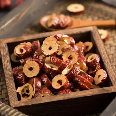Sliced dried red dates in wooden box for kidney health and renal protection herbal tea