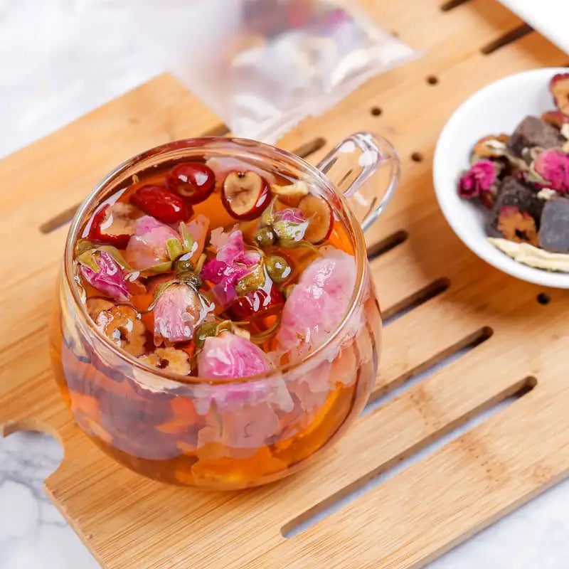 Floral herbal tea in a glass mug promotes blood circulation and alleviates menstrual pain