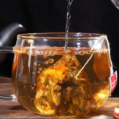 Glass teacup with tea bag from Slimming Tea promoting intestinal motility during golden hour